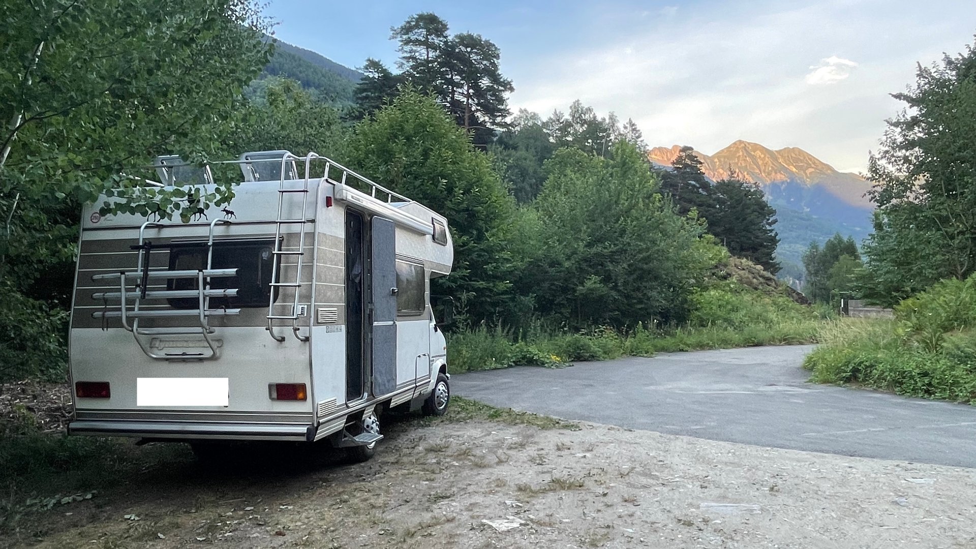 Camper van parked in an open landscape, months into life on the road